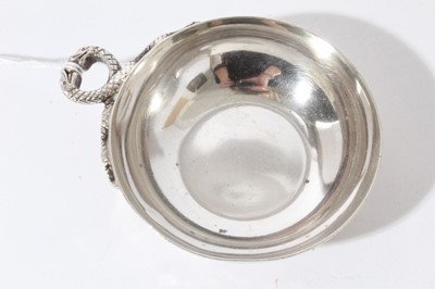 Lot 67 - Contemporary silver wine taster of circular form with intertwined Serpent handle, (London 1972), maker L.P., 2.5oz, 11cm in diameter