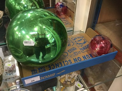 Lot 49 - Victorian Green Witches Ball together with another smaller glass burble (2)
