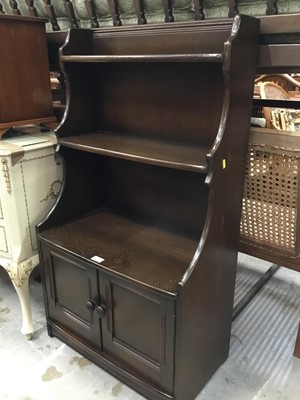 Lot 962 - Ercol elm waterfall bookcase with two doors below 61 cm wide, 111 cm high,34 cm deep