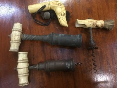 Lot 187 - Three Victorian cork screws and a faux ivory parasol handle