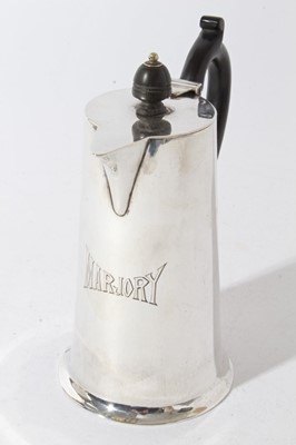 Lot 28 - George V Silver hot water pot of tapered form with flared foot, body engraved Marjory, with ebony handle and finial (Sheffield 1923), maker, Sutherland & Roden, all at 12.5oz, 16.5cm in height