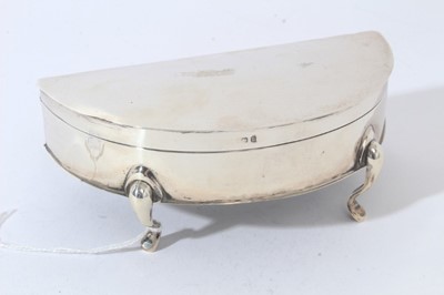 Lot 19 - George V Silver ring / jewellery box of crescent form with hinged lid, opening to reveal fitted silk and velvet lined interior, raised on four feet, (Birmingham 1919) 14.2cm in length