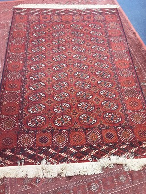 Lot 1112 - Eastern rug with geometric decoration on red ground, 203cm x 142cm