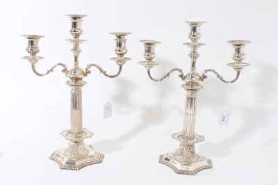 Lot 114 - Pair of George VI silver candelabra, each with fluted columns and gadrooned borders, removable twin branches and three candle holders with removable sconces (Birmingham 1937)