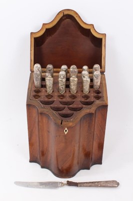 Lot 277 - George III mahogany knife box with serpentine front, barber pole stringing and fitted interior, containing an assortment of seventeen silver and white metal handled knives, 24cm wide x 35.5cm high