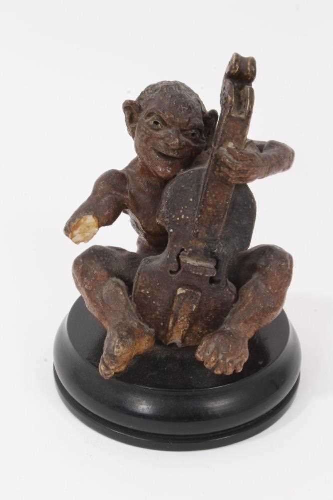 Lot 12 - Martin Brothers salt glazed pottery sculpture of a grotesque figure playing a cello