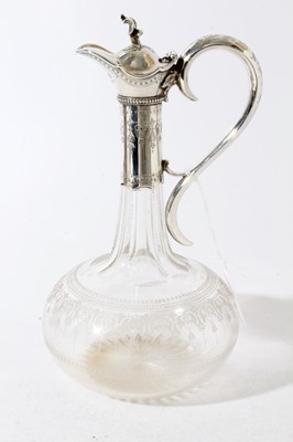 Lot 127 - Victorian silver mounted glass claret jug of onion form with star cut base, wheel engraved and etched decoration, faceted neck and silver mounts with engraved decoration