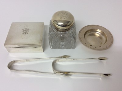 Lot 191 - Two pairs of Georgian silver sugar tongs, Victorian silver mounted and glass bodied inkwell, contemporary silver armada dish and a silver cigarette box of square form