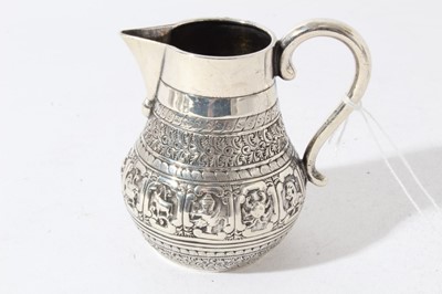 Lot 48 - Victorian silver Indian Mughal style milk / cream jug embossed with nine signs of the Zodiac, each within a scrolled panel, (London 1877) maker Alexander Macrae, 3.5oz, 9cm in height