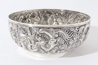 Lot 39 - Good quality late 19th century Chinese Export silver bowl with embossed decoration depicting Dragons amongst clouds, marks to base for Wang Hing