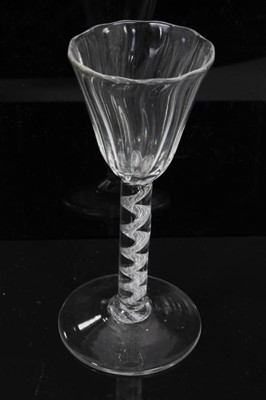 Lot 164 - Georgian air twist wine glass, c.1750, the pointed round funnel bowl with slightly wrythen vertical moulding, the stem with single spiral cable over a conical foot, 13.75cm height