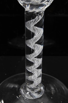 Lot 164 - Georgian air twist wine glass, c.1750, the pointed round funnel bowl with slightly wrythen vertical moulding, the stem with single spiral cable over a conical foot, 13.75cm height