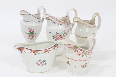 Lot 141 - A rare Keeling and Co Low Bucket Shaped cream jug, circa 1795, pattern number 292, and four helmet shaped cream jugs, circa 1795