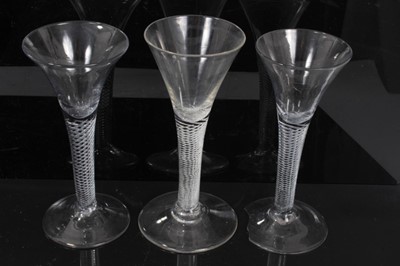 Lot 152 - Three Georgian wine glasses, c.1750, all with drawn trumpet bowls on multi-spiral air twist stems, 16cm to 16.75cm height