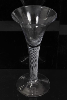 Lot 152 - Three Georgian wine glasses, c.1750, all with drawn trumpet bowls on multi-spiral air twist stems, 16cm to 16.75cm height