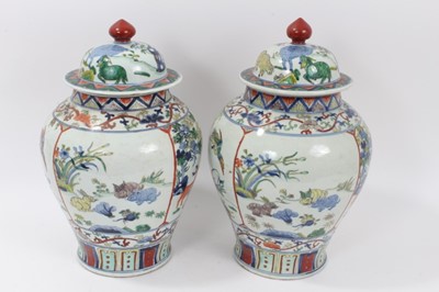 Lot 212 - Pair of Chinese Famille verte baluster vases and covers, each with six character Jiajing mark
