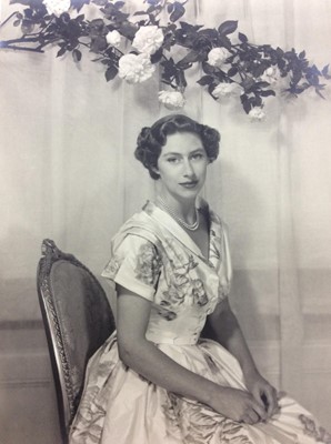 Lot 66 - H.R.H. The Princess Margaret , fine mid-1950s Cecil Beaton black and white portrait photograph of the attractive Princess in a floral dress , mounted on card and signed by the photographer 19.5 x 1...