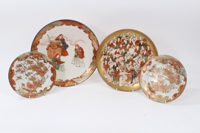 Lot 143 - Japanese Meiji period charger painted with three female figures and a cauldron, together with a further charger and a pair of smaller dishes, the largest measuring 33.5cm diameter