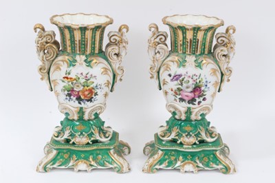 Lot 70 - Pair of 19th century French porcelain vases, of baluster form with scrollwork handles and base, painted with floral sprays on a green gilt ground, 26cm height