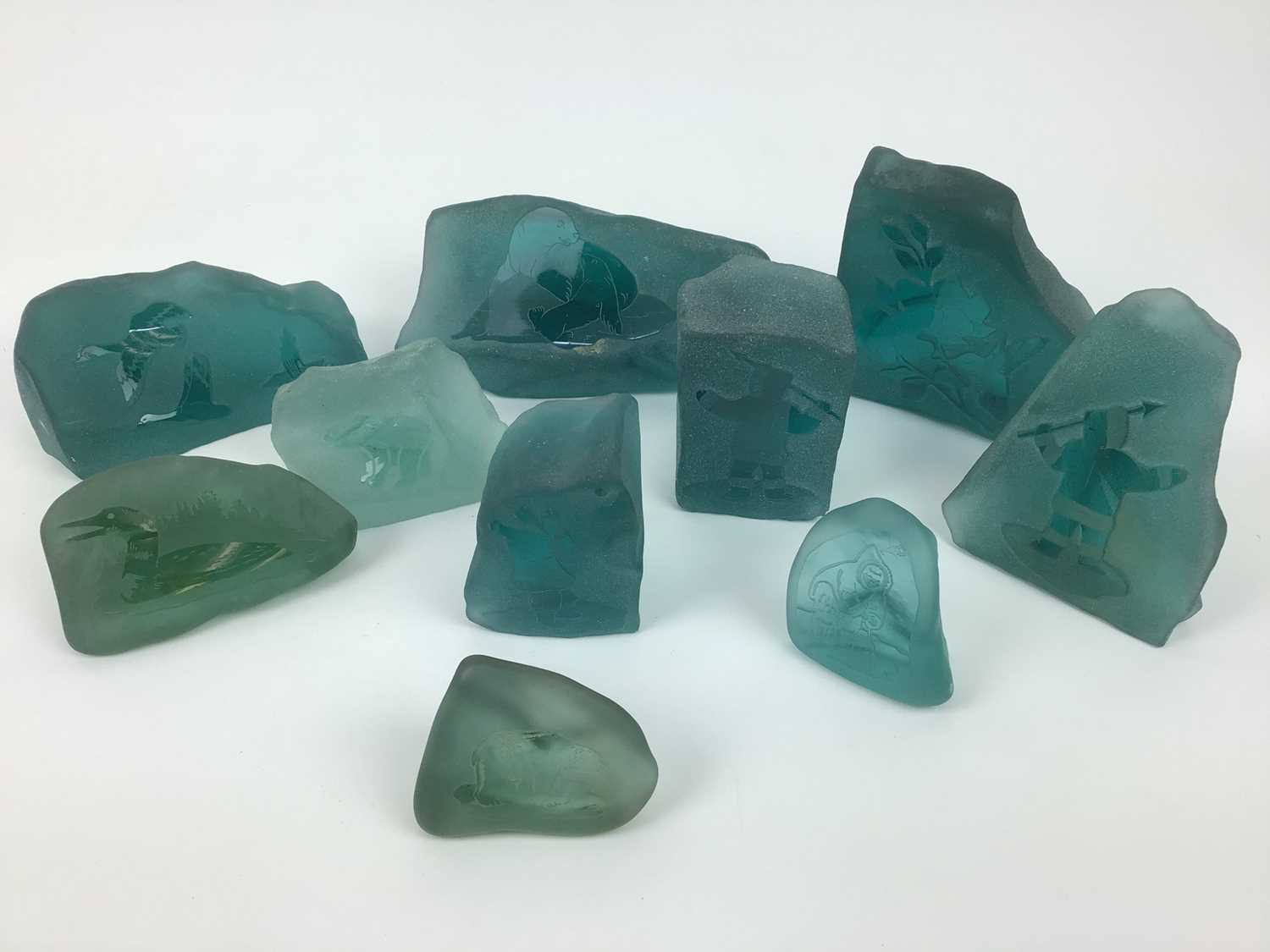 Lot 234 - Ten Canadian Inuit etched and engraved frosted sea glass paperweights by Siku and others (10)