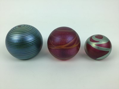 Lot 612 - Three Okra art glass paperweights by Richard Goulding (3)