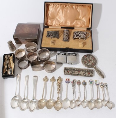 Lot 134 - George V silver cigarette box of rectangular form with domed hinged cover (Birmingham 1924) together with a silver three piece cruet set and a quantity of silver and white metal flatware and napkin...