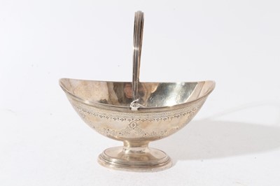 Lot 150 - Gerorge III silver dish of navette form with brite cut engraved decoration, with reeded swing handle, raised on oval pedestal foot with reeded decoration, (London 1790), all at 12oz, 18cm in length