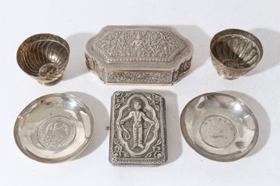 Lot 170 - Pair of white metal dishes set with coins together with an Indian white metal cigarette case, an Indian white metal table top snuff / tobacco box and two white metal cups (6 items)