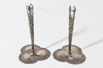 Lot 192 - Pair of early 20th century American silver bud vase holders, pierced tapered stems with floral decoration, on decorative bases, stamped Tiffany & Co, Sterling, all at 2oz