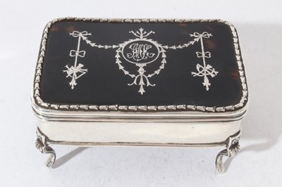 Lot 193 - Edwardian silver jewellery / trinket box of rectangular form, with hinged lid set with tortoiseshell and inlaid with Adam style decoration in silver, velvet lined interior, raised on four cabriole...