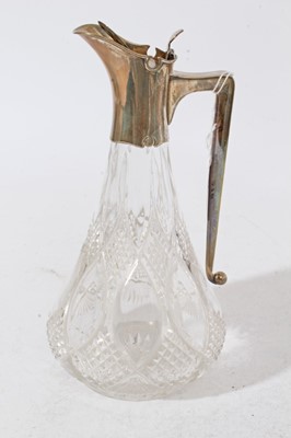Lot 216 - Late Victorian silver mounted cut glass claret jug of tear drop form with star cut base, silver mount with hinged cover and angular handle (London 1898), maker Joseph Grinsell & Sons, 25cm in heigh...