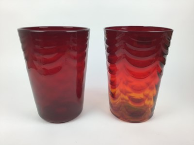 Lot 578 - Two large Whitefriars Ruby red waved ribbed vases, 29cm high
