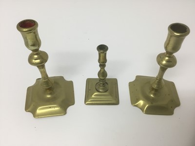 Lot 68 - Pair of early 18th century brass squat candlesticks, together with a similar taperstick