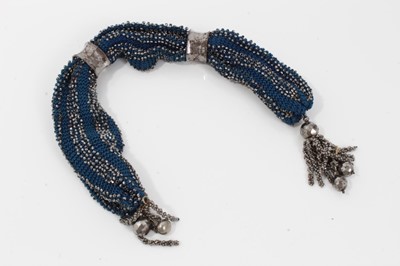 Lot 108 - Fine Georgian cut steel and blue woven silk misers purse , the steel work retaining most original mirror finish 32 cm long