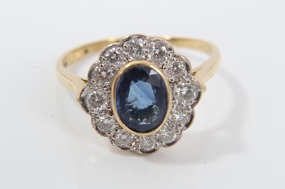 Lot 27 - Sapphire and diamond cluster ring with an oval mixed cut blue sapphire measuring approximately 7.75mm x 5.75m x 2.8mm surrounded by twelve brilliant cut diamonds on 18ct yellow gold shank. Estimate...