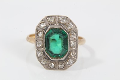 Lot 31 - 1920s diamond and green stone cocktail ring with a step cut green stone surrounded by a border of old cut and single cut diamonds, on 18ct gold shank. Ring size O½.