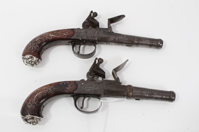 Lot 117 - Pair fine 18th century Queen Anne Flintlock pocket pistols with turn- off cannon barrels by Adams London , trigger guard safety's , fine silver wire inlaid walnut grips with grotesque mask but caps...