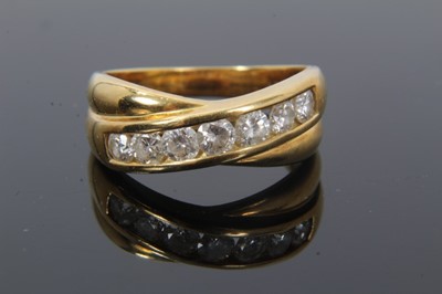 Lot 40 - Diamond ring with two cross-over bands and a row of seven channel set brilliant cut diamonds estimated to weigh approximately 0.70cts, ring size N½