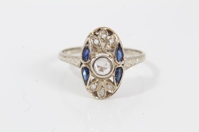 Lot 231 - Art Deco diamond and sapphire plaque ring with an oval openwork plaque with a central rose cut diamond, four pear cut blue sapphires (possibly synthetic) and rose cut diamonds, pierced gallery and...