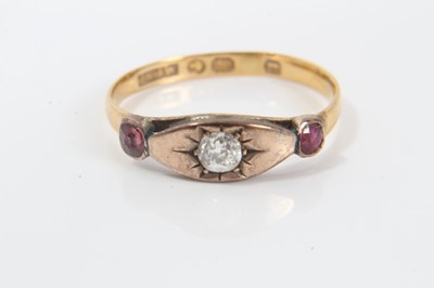 Lot 243 - Victorian diamond and ruby three stone ring with a central old cut diamond in gypsy-style setting flanked by two rubies in 9ct rose gold setting, possibly later mounted on a 22ct band, ring size O½