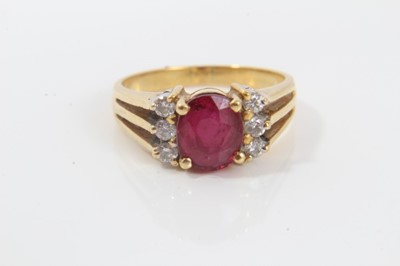 Lot 270 - 18ct gold diamond and red stone dress ring with an oval mixed cut red stone (possibly a synthetic ruby) flanked by six brilliant cut diamonds on 18ct gold shank. Ring size I½.