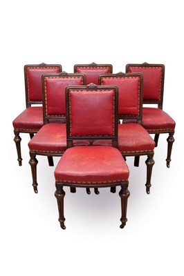 Lot 740 - Set of six Victorian walnut and close stud upholstered dining chairs, each with moulded framed and square pad back and seat on knopped fluted legs and castors