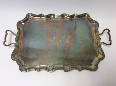 Lot 148 - Edwardian silver two handled tray of rectangular form with shaped border and central engraved crest and coat of arms, London 1902, maker Charles Stuart Harris, retailed by Robt. Jones & Son. Liverp...