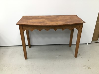 Lot 57 - Old pine bow front side table with gothic arched frieze on square taper legs