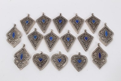 Lot 3 - Collection of 16 Eastern white metal pendants each set with lapis lazuli. Sizes from 3cm to 4.3cm