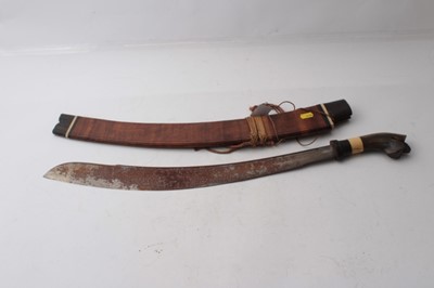 Lot 336 - Two Early 20th century Borneo Parang swords, one with horn and bone hilt , heavy curved blade in horn mounted wood sheath, the other of simple form (2)