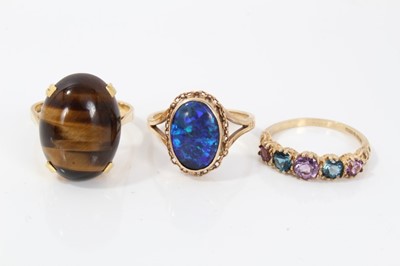 Lot 154 - 18ct gold tiger’s eye cocktail ring, 9ct gold opal ring and 9ct gold multi gem ring (3)