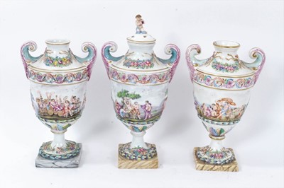 Lot 18 - Good 19th century Capodimonte garniture of urns, decorated in relief with mythological scenes, on squared marbled bases, 24cm to 29cm height