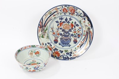 Lot 22 - Early Japanese Edo period Imari dish, c.1700, painted with vases of flowers, further floral patterns, and two phoenixes around the edge, repaired, 32cm diameter