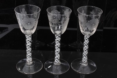 Lot 38 - Georgian cordial glasses comprising a pair with Jacobite engraved rose, thistle, star and leaf decoration with double series opaque twist stems and an identical glass with similar decoration with F...